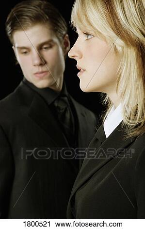 Young Adult male & female in suits View Large Photo Image Stock Image - Young Adult male & female in suits. Fotosearch