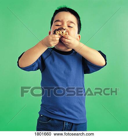 Young boy eating a cookie View Large Photo Image Stock Image - Young boy eating a cookie. Fotosearch