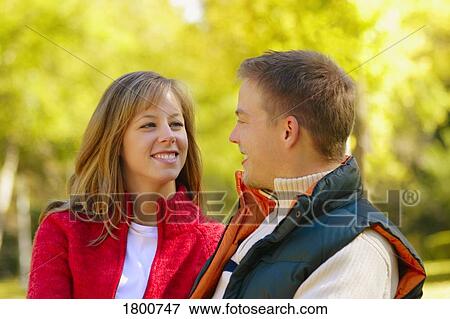 Stock Photo - Young couple looking at each other. Fotosearch