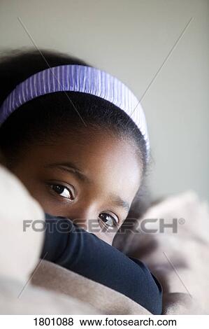 Stock Photo - Young girl with head resting on arms. Fotosearch