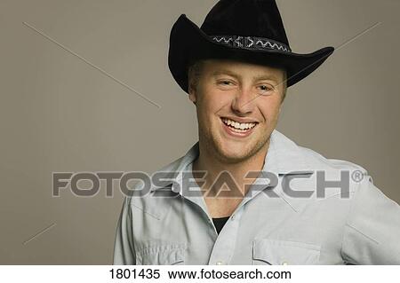Young man wearing cowboy hat View Large Photo Image Stock Photography - Young man wearing cowboy hat. Fotosearch