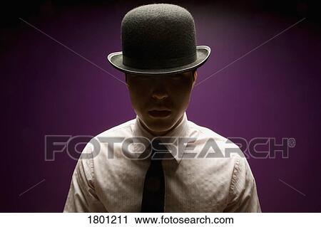 Stock Image - Young man wearing top hat and tie. Fotosearch