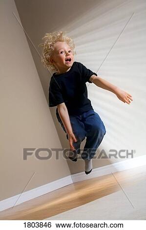 A boy jumping in the air View Large Photo Image Stock Photograph - A boy jumping in the air. Fotosearch