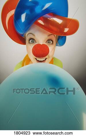 Stock Image - A clown smiling with balloons. Fotosearch