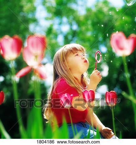 A girl blowing bubbles View Large Photo Image Stock Photograph - A girl blowing bubbles. Fotosearch