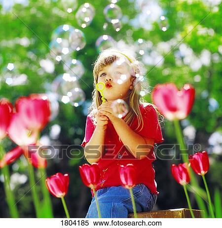 A girl blowing bubbles View Large Photo Image Stock Photography - A girl blowing bubbles. Fotosearch