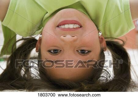 A girl smiling and doing headstand View Large Photo Image Stock Image - A girl smiling and doing headstand. Fotosearch