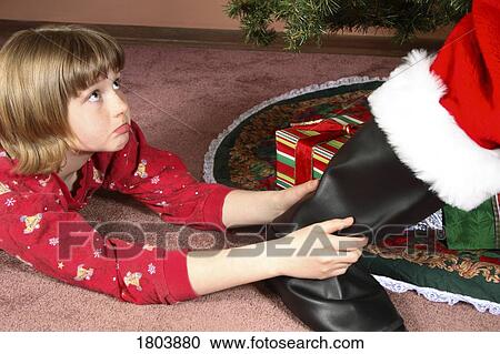 Stock Image - A girl stopping santa claus. Fotosearch