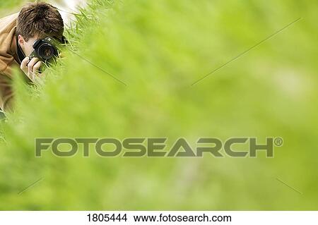Picture - A man taking photograph. Fotosearch