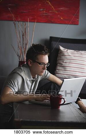 Stock Photography - A man working on laptop. Fotosearch
