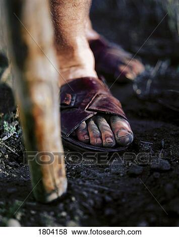 Stock Photo - A person standing with cane. Fotosearch