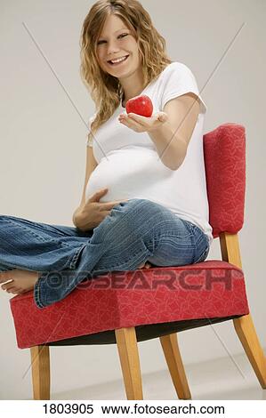A pregnant woman holding apple View Large Photo Image Stock Photography - A pregnant woman holding apple. Fotosearch