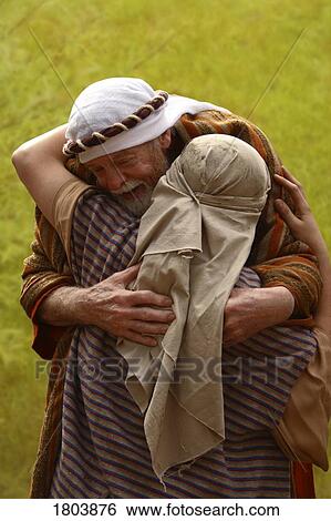 A senior man hugging another person both dressed in robes and cloths on heads View Large Photo Image Stock Photograph - A senior man hugging another person both dressed in robes and cloths on heads. Fotosearch