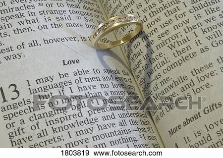 Stock Photo - A wedding ring on an open Bible. Fotosearch
