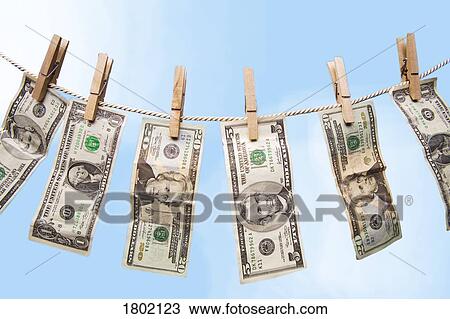 Stock Image - American bills hanging on a clothes line. Fotosearch