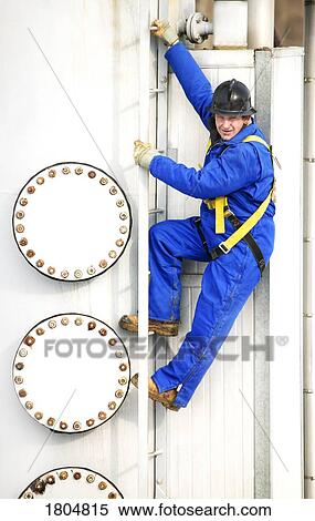 An industrial worker on a ladder View Large Photo Image Stock Photography - An industrial worker on a ladder. Fotosearch