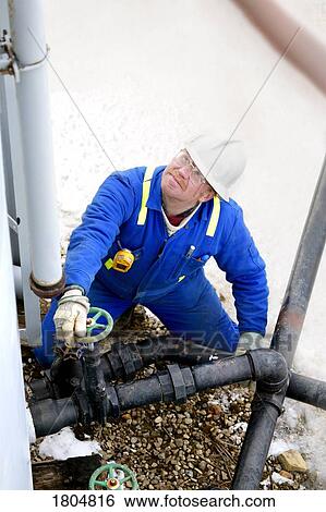 An oilfield worker working by the pipettes View Large Photo Image Stock Photograph - An oilfield worker working by the pipettes. Fotosearch