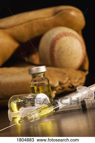 Stock Image - Baseball glove with syringes and vials. Fotosearch