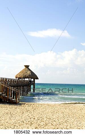 Beach with pier overlooking sea View Large Photo Image Stock Image - Beach with pier overlooking sea. Fotosearch