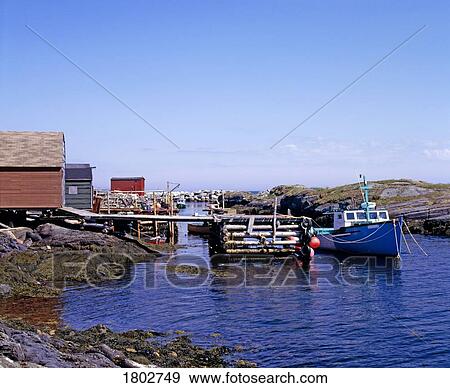 Stock Photo - Boat docked at rocky shore. Fotosearch