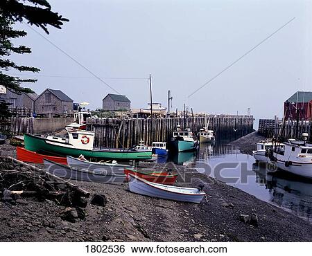 Boats on shore with dock in background View Large Photo Image Stock Photograph - Boats on shore with dock in background. Fotosearch