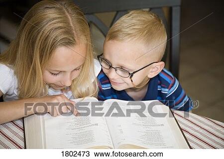 Boy and girl reading the Bible together View Large Photo Image Stock Image - Boy and girl reading the Bible together. Fotosearch