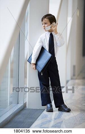 Boy dressed up like businessman and talking on cell phone View Large Photo Image Stock Photography - Boy dressed up like businessman and talking on cell phone. Fotosearch