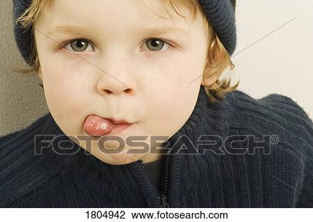 Stock Image - Boy sticking tongue out. Fotosearch