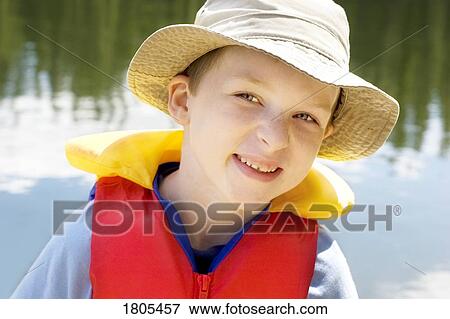 Stock Photo - Boy wearing a lifejacket. Fotosearch