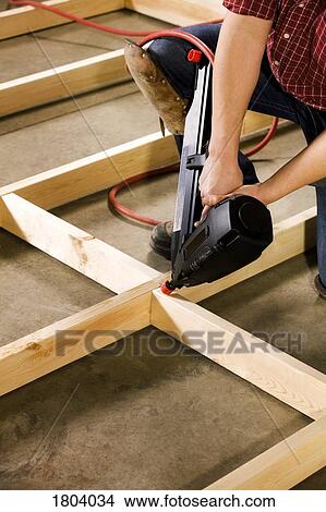Picture - Carpenter working with power tool. Fotosearch