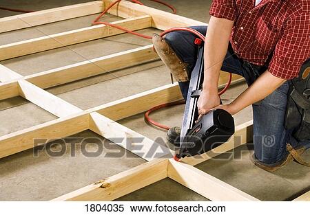 Stock Photography - Carpenter working with power tool. Fotosearch