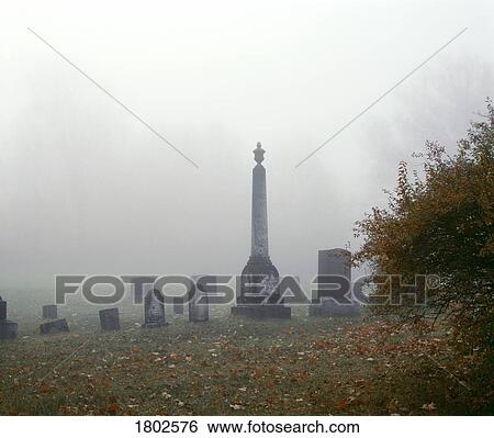 Cemetery with tombstones in the fog View Large Photo Image Stock Photograph - Cemetery with tombstones in the fog. Fotosearch
