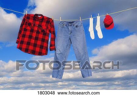 Clothes hanging on clothes line View Large Photo Image Stock Photo - Clothes hanging on clothes line . Fotosearch