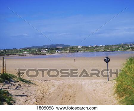 Stock Photo - Co Galway, Causeway across the beach to Omey Island, Ireland. Fotosearch