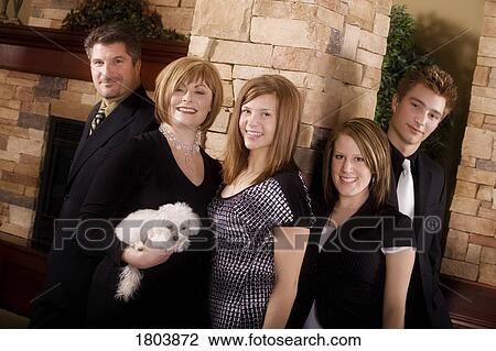 Family smiling and looking at the camera View Large Photo Image Stock Image - Family smiling and looking at the camera. Fotosearch