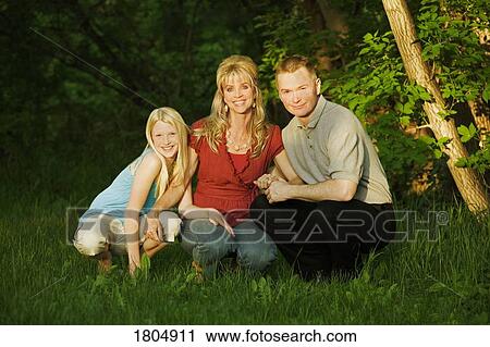 Family smiling and sitting in the park View Large Photo Image Stock Image - Family smiling and sitting in the park. Fotosearch