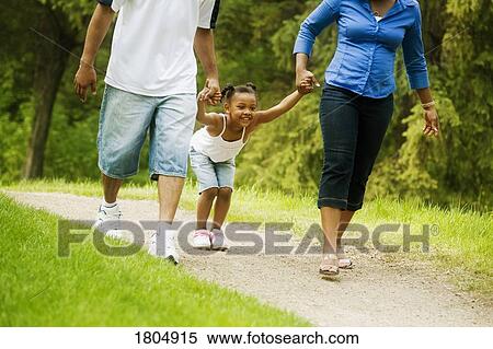 Stock Photography - Family walking on pathway. Fotosearch