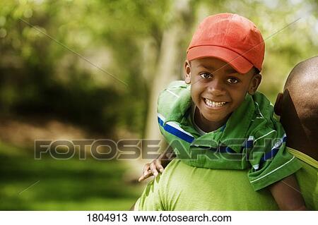 Father carrying son on shoulders View Large Photo Image Stock Image - Father carrying son on shoulders. Fotosearch