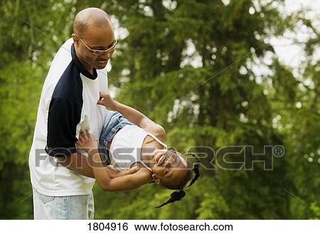 Stock Photograph - Father playing with daughter. Fotosearch
