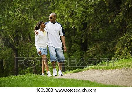 Father walking with daughter in park View Large Photo Image Stock Image - Father walking with daughter in park. Fotosearch