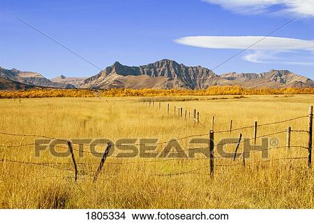 Fence line and mountain in the fall View Large Photo Image Picture - Fence line and mountain in the fall. Fotosearch