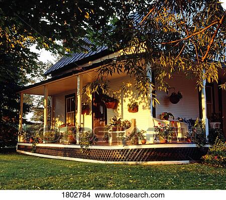 Picture - Front porch with flowers in summer. Fotosearch