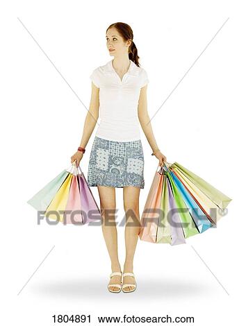 Front view of a woman holding shopping bags View Large Photo Image Stock Image - Front view of a woman holding shopping bags. Fotosearch