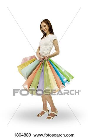 Front view of a woman holding shopping bags View Large Photo Image Stock Photo - Front view of a woman holding shopping bags. Fotosearch