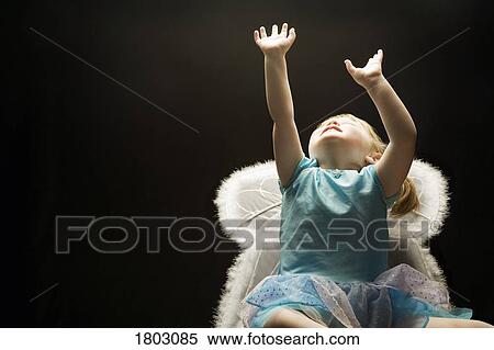 Stock Photography - Girl (3-4) wearing angel's costume. Fotosearch