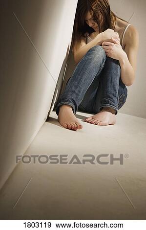 Girl huddled in corner View Large Photo Image Stock Photo - Girl huddled in corner. Fotosearch