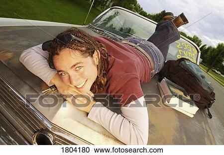 Girl posing on hood of a rusted car View Large Photo Image Stock Image - Girl posing on hood of a rusted car. Fotosearch