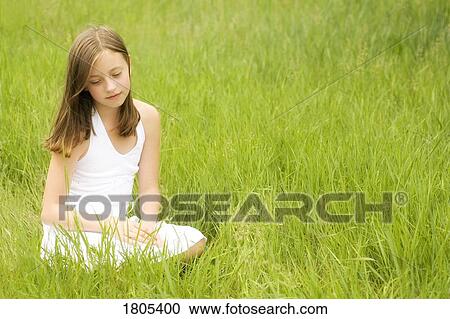 Stock Image - Girl sitting in the park. Fotosearch