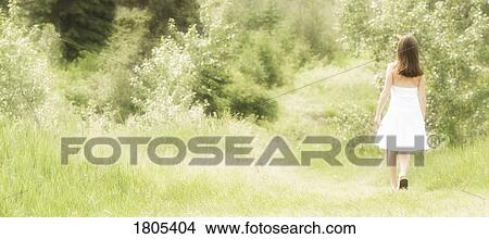 Girl walking down a path View Large Photo Image Picture - Girl walking down a path. Fotosearch