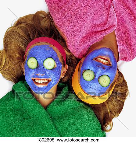 Stock Photo - Girls having a facial. Fotosearch